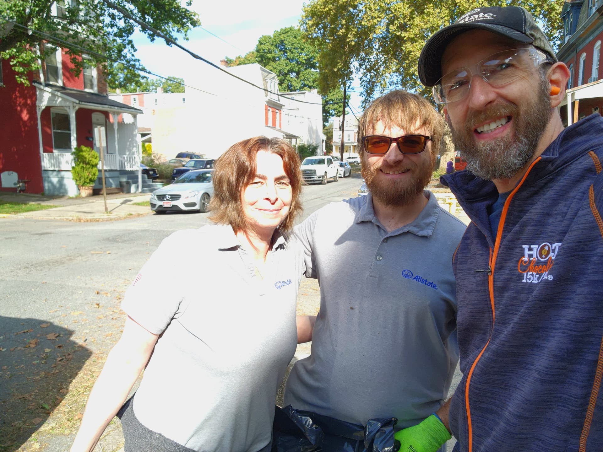 Three agency team members volunteering at a neighborhood cleanup in Harrisburg, PA