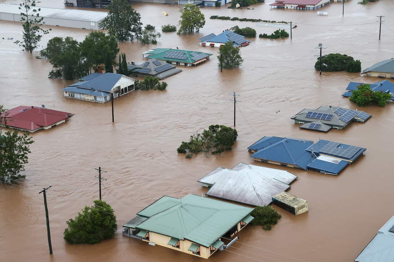 Aerial view of a neighborhood with homes surrounded by floodwater